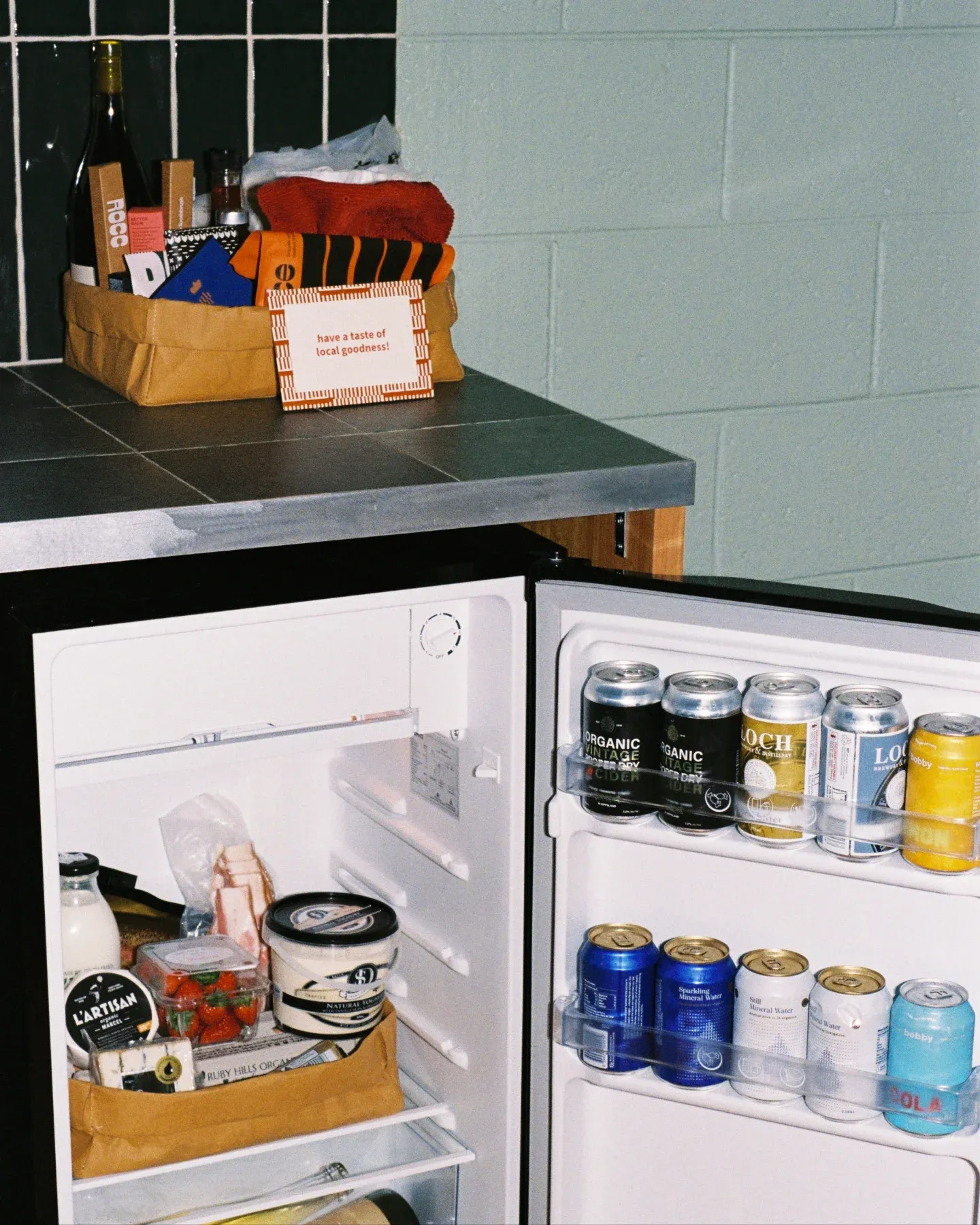 the River Drive Motel minibar fridge filled with drinks and treats