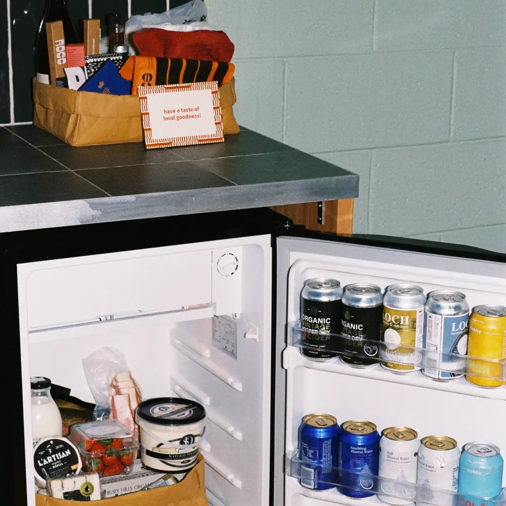 the River Drive Motel minibar fridge filled with drinks and treats